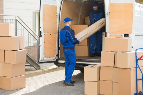 Furniture pick-up service removing a sofa in Clapham