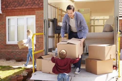 Trained removal staff using lifting techniques during a house move