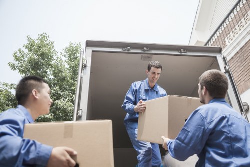 Professional movers transporting office furniture during a Clapham commercial move