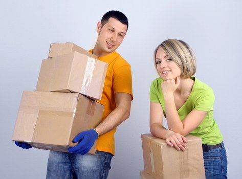 Removal team carrying furniture down stairs in a Clapham apartment move