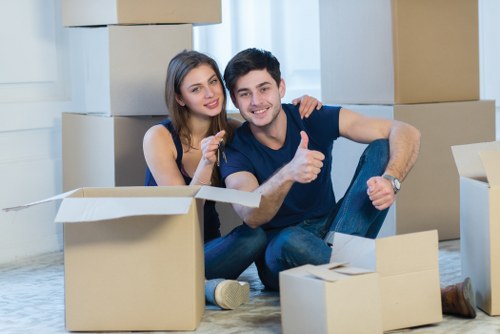 Safe and insured movers in Clapham handling boxes carefully
